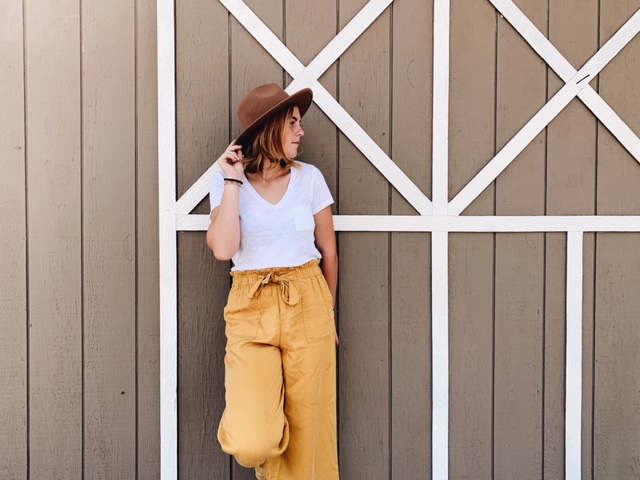 White shirt, yellow pants, and hat 