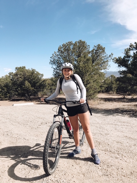 mountain bike, helmet, black shorts, grey shirt